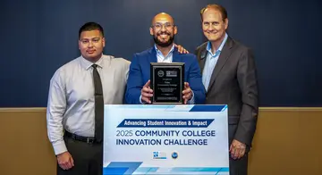 Adrian Carrillo, Jonathan Ford, and Jeff Horvath stand with an award plaque