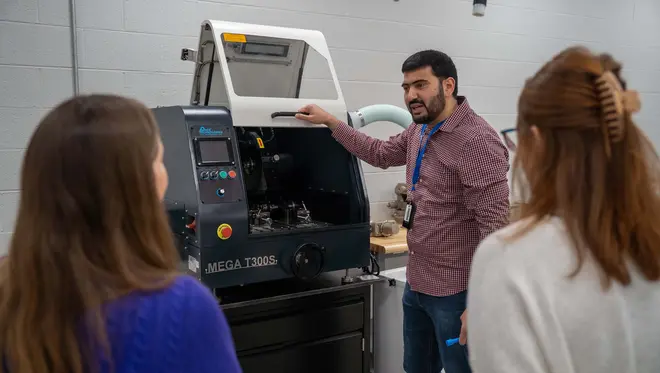 Dr. Anass Nassef shows new lab equipment to TCC faculty and staff