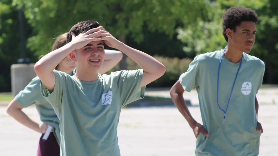 Student watches solar-powered vehicles race