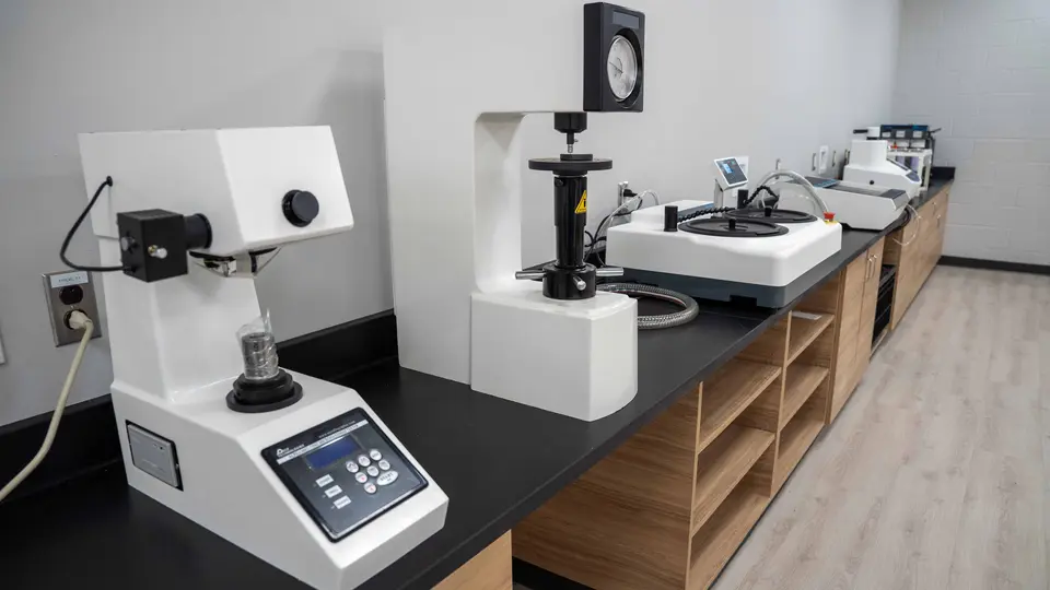 Several small machines sit on a counter in the Materials Properties Lab.