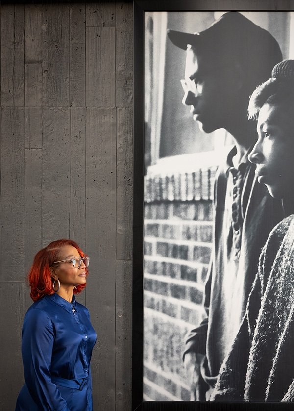 TCC Faculty Member Corinice Wilson Faces a large black and white photograph of children in the Greenwood Rising Museum.