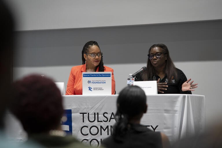 Dr. Ebony Johnson listens as Dr. Regina Lewis speaks